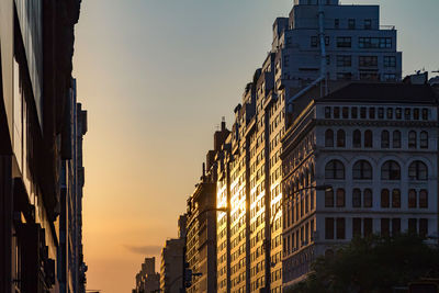 Low angle view of buildings against sky during sunset