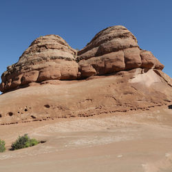 Rock formations in desert against clear blue sky