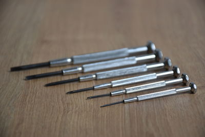 High angle view of screwdrivers on wooden table