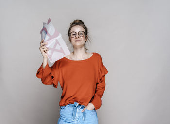 Portrait of young woman holding letter x template