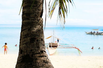 Rear view of man on beach against sky