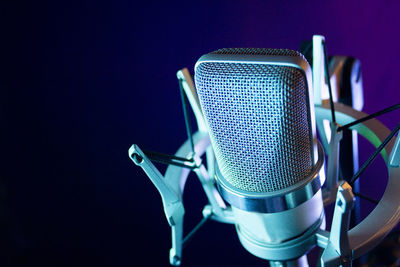 Close-up of microphone against blue background