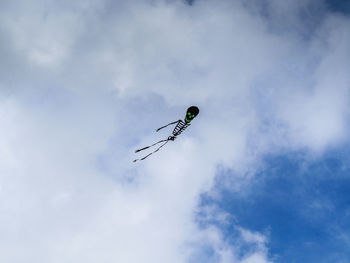 Low angle view of skeleton shaped kite flying in sky