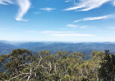 Scenic view of mountains against blue sky