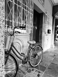 Bicycle parked against building