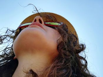 Low angle view of woman against clear sky