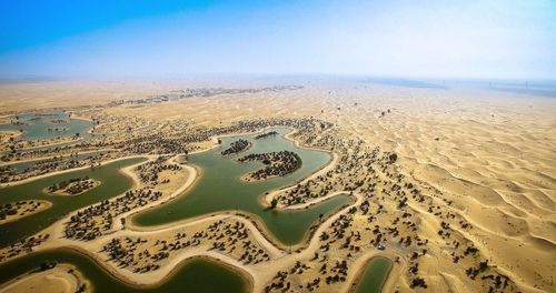 Aerial view of sand dunes against clear sky