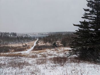 Scenic view of snow covered land against clear sky