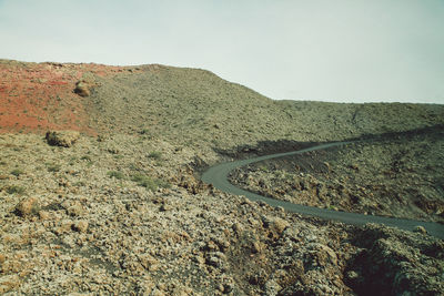 Scenic view of mountain road against clear sky