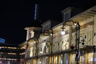 Low angle view of illuminated buildings against sky at night