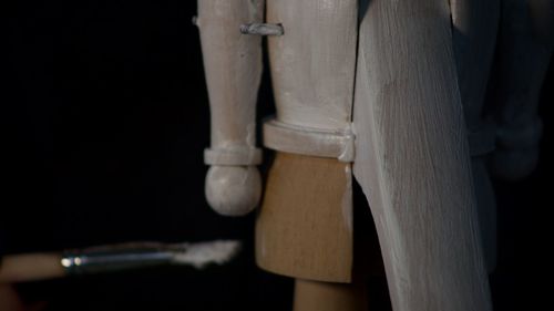 Low section of man standing on wooden floor