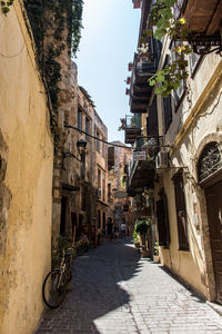 Narrow street amidst buildings in city