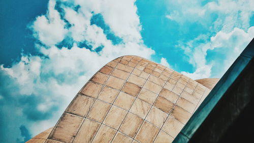 Low angle view of building against cloudy sky