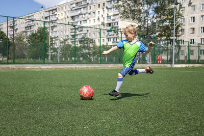 People playing soccer ball on field