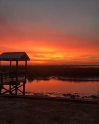 Scenic view of sea against orange sky