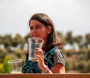 Woman drinking beer in glass