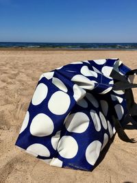 Umbrella on beach against sky