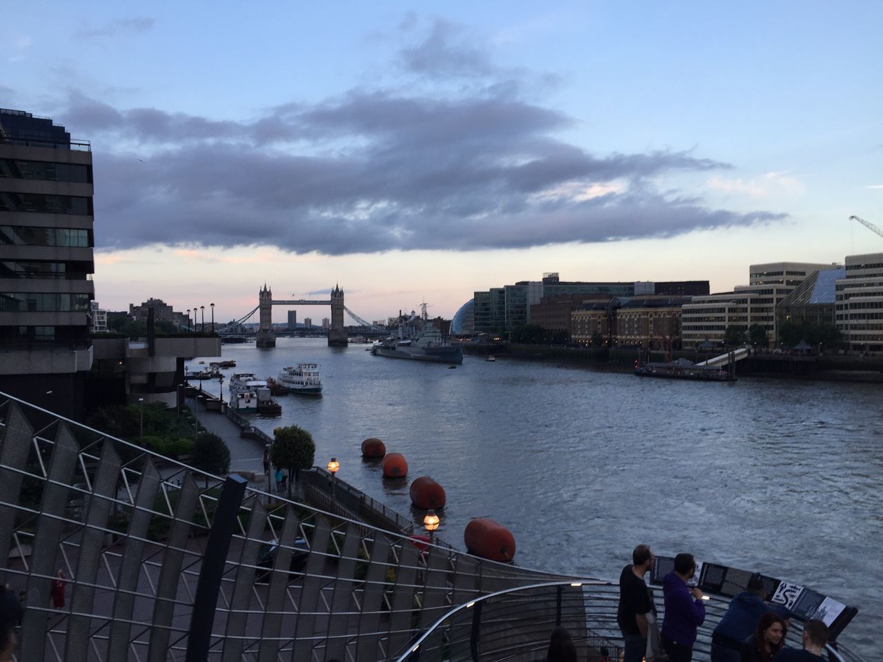 building exterior, architecture, built structure, water, sky, city, transportation, nautical vessel, mode of transport, cloud - sky, river, men, cityscape, boat, city life, railing, lifestyles, sea, harbor