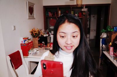 Portrait of smiling young woman at home