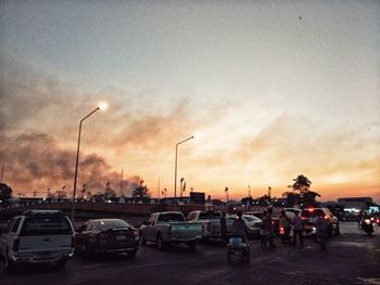 Traffic on road at sunset