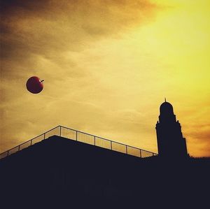 Low angle view of built structure against sky at sunset