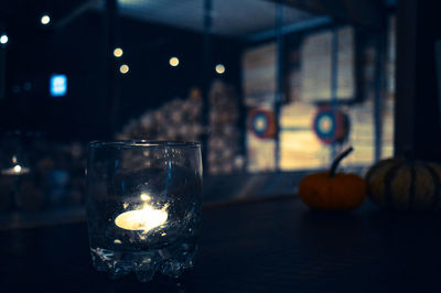 Close-up of illuminated candles on table