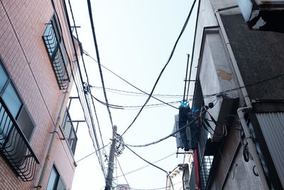 Low angle view of electricity pylon against sky