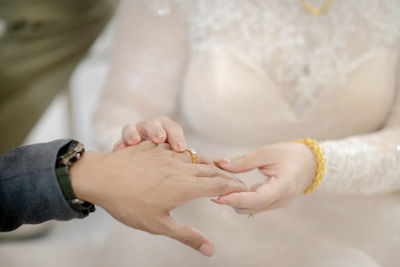 Midsection of bride holding hands