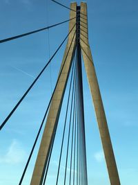 Low angle view of suspension bridge against sky