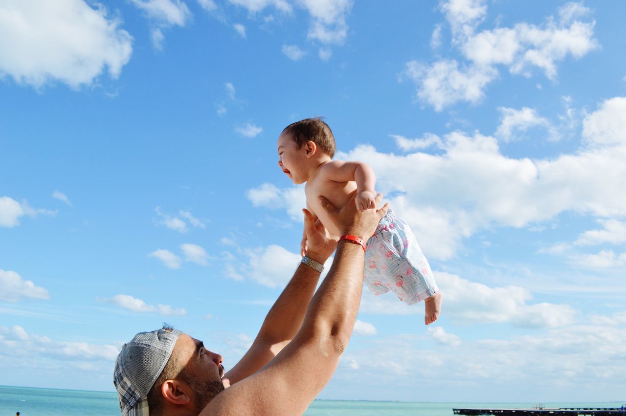 sky, cloud - sky, family, parent, men, males, leisure activity, real people, day, shirtless, lifestyles, water, nature, family with one child, sea, people, adult, son, outdoors, horizon over water, daughter