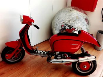 Close-up of red vintage car on hardwood floor