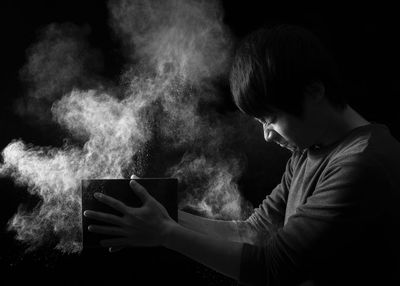 Close-up of man wearing black background