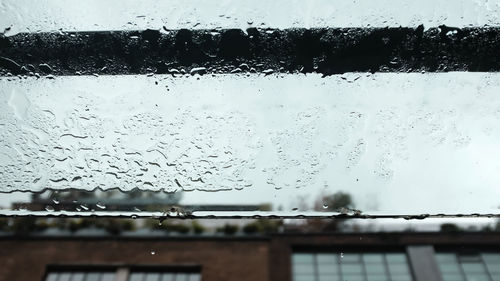 Raindrops on glass window during rainy season