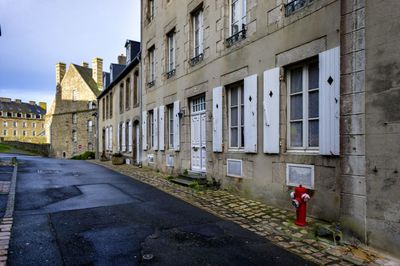 Street amidst buildings against sky