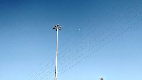 Low angle view of floodlight against clear blue sky