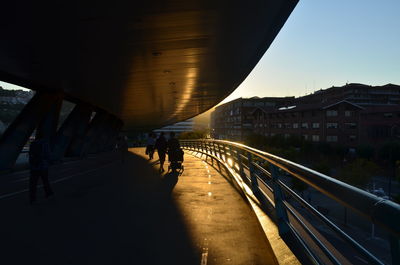 People walking on bridge in city