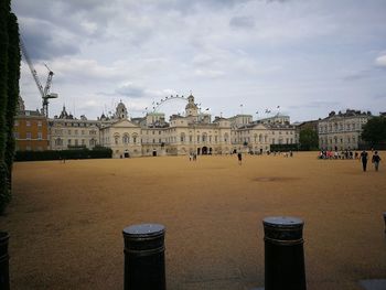 Buildings in town against cloudy sky