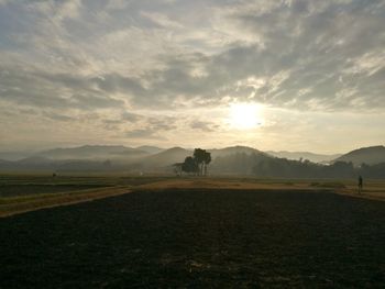 Scenic view of field against sky during sunset