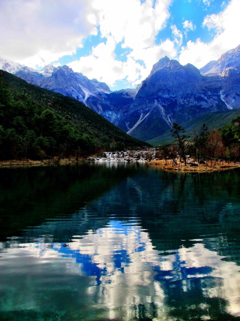 mountain, water, lake, mountain range, reflection, tranquil scene, tranquility, scenics, sky, beauty in nature, waterfront, nature, cloud - sky, idyllic, cloud, tree, non-urban scene, outdoors, river, day