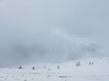 Scenic view of snow covered land against sky
