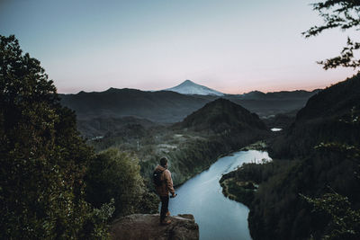 Rear view of woman walking on mountain