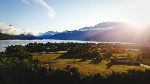 Scenic view of field and mountains against sky