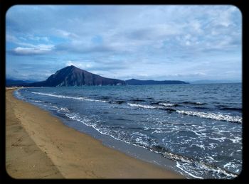 Scenic view of sea against cloudy sky