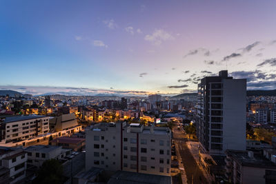 High angle view of buildings in city against sky during sunset