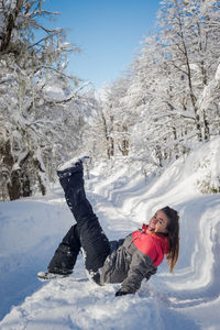 Woman on snow covered field against snowcapped mountain