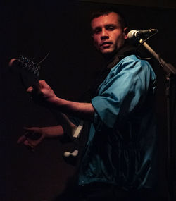 Side view portrait of young man playing music