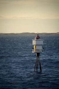 Lifeguard hut on sea against sky