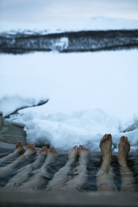 Four people bathing in cold lake in winter