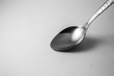 Close-up of wineglass on table against white background