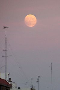 Low angle view of moon against sky at dusk